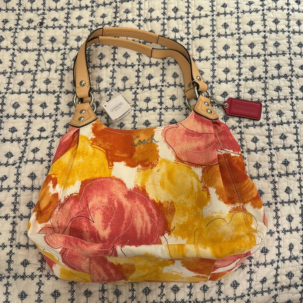 Floral Coach bag with matching wristlet. NWT. Fabric with leather trim.